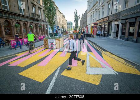 The changing face of the high street. The newly-pedestrianised Union Street in Dundee in Scotland, a previously busy city centre thoroughfare, has been painted with a colourful zebra crossing-style mural to encourage people to explore the street, some six months on from the evening of March 23 when Prime Minister Boris Johnson announced nationwide restrictions. Stock Photo