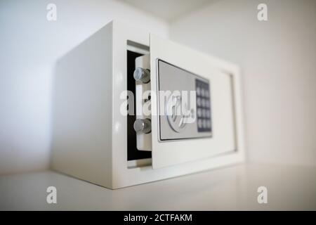 Metal safe inside an empty wooden closet in a hotel room Stock Photo