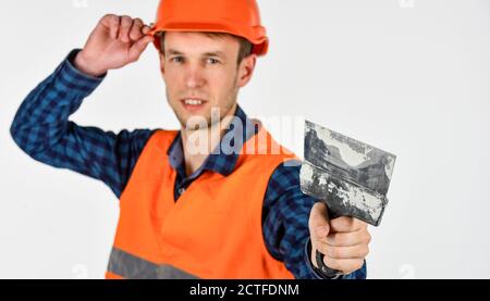 Plasterer in working uniform plastering tool putty knife, renovation concept. Stock Photo