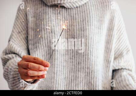 Woman holding festive burning sparkler Stock Photo