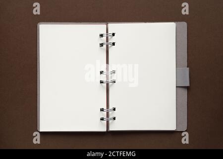 Top view of open empty notebook with cover from recycled paper on brown background Stock Photo