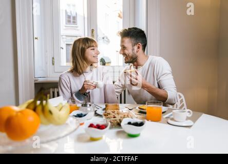Happy couple having healthy breakfast together at home Stock Photo