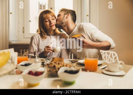 Happy couple having healthy breakfast together at home Stock Photo