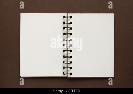 Top view of open empty notebook with cover from recycled paper on brown colorful background Stock Photo