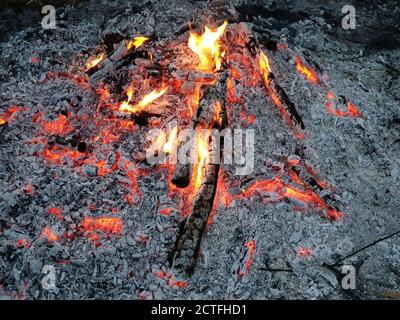 Glowing embers of burning wood log fire Stock Photo