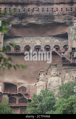 Sculptures of Buddhas are seen on the half of the mountain at the Maijishan Grottoes, a series of 194 caves cut in the side of the hill of Majishan, T Stock Photo