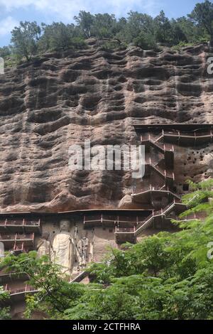 Sculptures of Buddhas are seen on the half of the mountain at the Maijishan Grottoes, a series of 194 caves cut in the side of the hill of Majishan, T Stock Photo