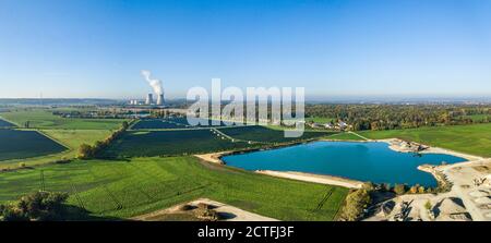 Aerial view from the Donauried near Lauingen with the cooling towers of the Gundremmingen nuclear power plant, a solar park and gravel mining Stock Photo