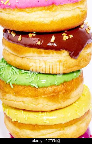 A pile of glazed donuts isolated on white background. Junk food Stock Photo