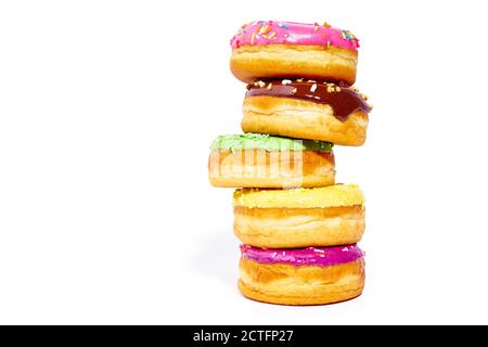 A pile of glazed donuts isolated on white background with copy space. Junk food Stock Photo