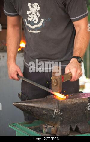 Blacksmith tools and actions forging iron objects Stock Photo - Alamy
