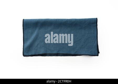 Flat lay with blue linen kitchen napkin isolated on white background. Folded cloth for mockup with copy space, top view Stock Photo