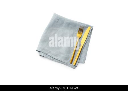 Flat lay empty folded linen napkin and golden cutlery isolated on white background. Fork and knife top view Stock Photo