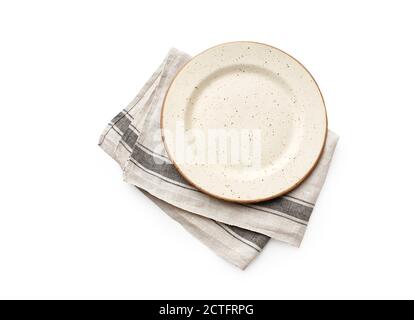 Flat lay with beige designed empty ceramic plate with rustic linen kitchen napkin isolated on white background top view with copy space Stock Photo