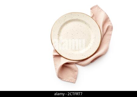 Flat lay beige empty plate and folded pink linen towel isolated on white background top view with copy space Stock Photo
