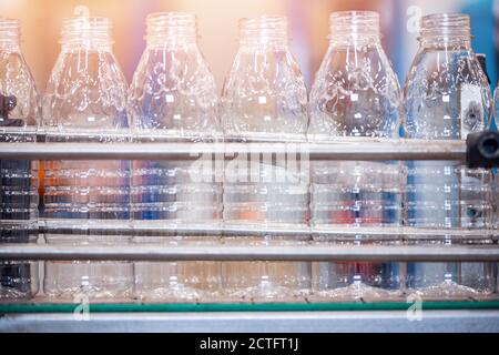 Preforms for making PET plastic bottles. Blank for production of containers for milk or beer. Line factory industry equipment Stock Photo