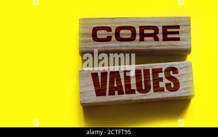 core values words on wooden blocks on yellow background. Business ethics concept Stock Photo