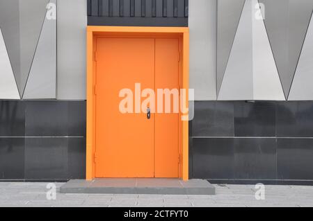 closed metal fire door in orange color. Stock Photo