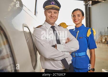 Friendly cabin crew members feeling happy to work together Stock Photo