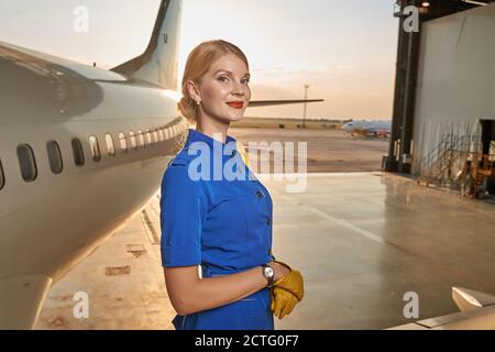 Friendly mirthful airline hostess waiting for the working day Stock Photo