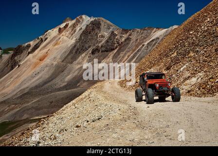 Modified Jeep on Alpine Loop, crossing scree deposits near Engineer Pass, San Juan Mountains, Colorado, USA Stock Photo