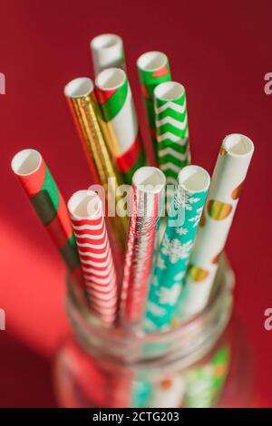 New Year Christmas background. Celebration drinking cocktail party straws in glass bottle. Stock Photo