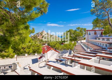 Small Red church of Panagia Lamiotissa with large sitting area for celebrations on Karpathos Island, Greece Stock Photo