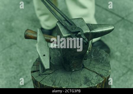Working metal tools in blacksmith's workshop, close-up, selective focus, toned Stock Photo