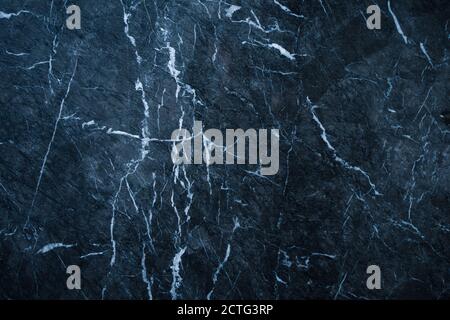 dark abstract marble texture background with blue tint and white veins Stock Photo