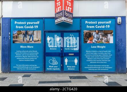 'Protect yourself from Covid'. Public health advice posters by Slough Borough Council displayed in city centre. No people Stock Photo