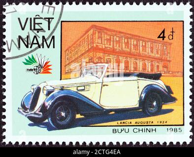 VIETNAM - CIRCA 1985: A stamp printed in North Vietnam from the 'Italia '85 International Stamp Exhibition, Rome' issue shows Lancia Augusta, 1934. Stock Photo
