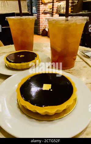 Chocolate tarts and drinks on café table Stock Photo