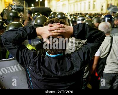 Sofia, Bulgaria. 22 Sep 2020. Protester holding his hands behind the head showing peaceful intentions during clashes with the police. The situation es Stock Photo