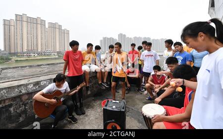 Yichun. 16th Sep, 2020. Photo taken on Sept. 16, 2020 shows athletes from Yichun Aquatic Sports Base amusing themselves after a rowing training session in Yichun, east China's Jiangxi Province. Founded in 1999, Yichun Aquatic Sports Base aims at the back-up personnel cultivation for rowing and canoe events. Credit: Hu Chenhuan/Xinhua/Alamy Live News Stock Photo