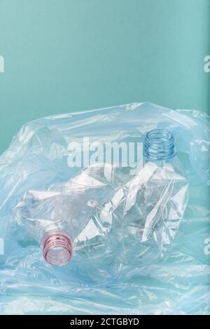 Used crushed plastic bottles on blue background. Stock Photo