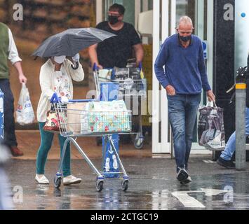 New Forest, Hampshire. 23rd September 2020. UK Weather. Shoppers at Tesco in the New Forest are caught out by heavy rain showers. Credit Stuart Martin/Alamy Live News Stock Photo