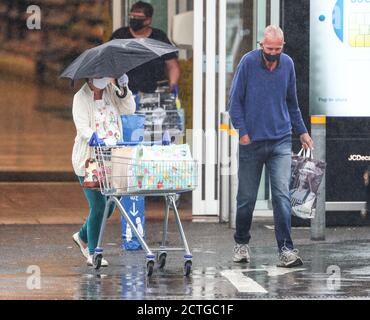 New Forest, Hampshire. 23rd September 2020. UK Weather. Shoppers at Tesco in the New Forest are caught out by heavy rain showers. Credit Stuart Martin/Alamy Live News Stock Photo