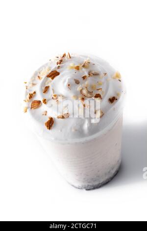 Vanilla milkshake in plastic takeaway cup isolated on white