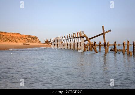 A view of derelict breakwaters surrounded by the sea on the North Norfolk beach at Happisburgh, Norfolk, England, United Kingdom. Stock Photo