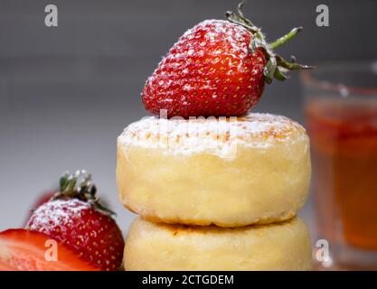 Cheese pancakes, homemade traditional Ukrainian and Russian syrniki with strawberries. Stock Photo