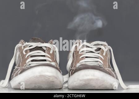 Dirty Shoes with Smoke. Stock Photo