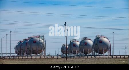 Zhanazhol oil deposit. Aktobe region, Kazakhstan: Sphere gas storage tanks for liquefying petroleum (natural) gas LPG, LNG. CNPC company. Panorama. Stock Photo