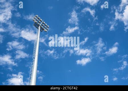 Close up vief of a floodlight in a professional sportsfield. with daylight cloudy blue sky. . High quality photo Stock Photo