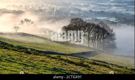Bamford village shrouded in a mist inversion Stock Photo