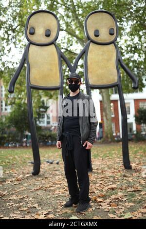 Artist and Hackney resident STIK at the launch of his 4-metre-high bronze sculpture ÔHolding Hands' - the culmination of a four-year collaboration between STIK and Hackney Council, and which has been solely funded by the artist - in Hoxton Square in east London. Stock Photo