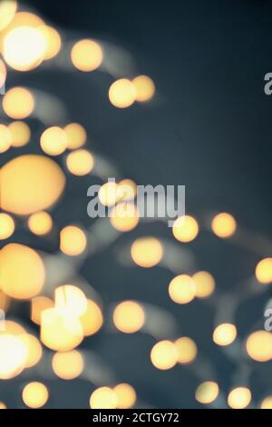 Abstract of blurred string of gold Christmas lights to use as texture or background. Stock Photo