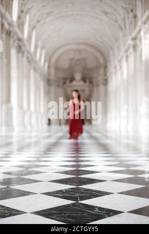 a girl with red dress in gallery Stock Photo