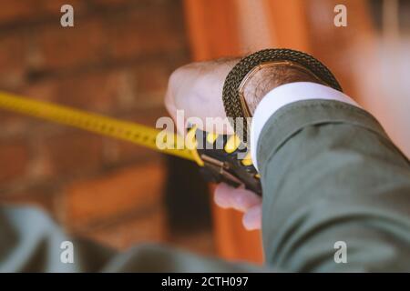 Hand of an architect at work with a measuring tape in his hand Stock Photo