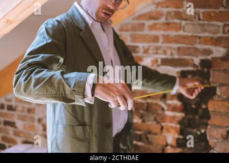 Architect at work with a measuring tape Stock Photo