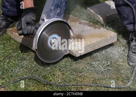 Angle grinder cutting bricks at a construction site Stock Photo